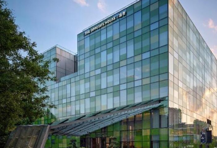Exterior of The Opposite House Hotel, a gay-friendly hotel with a modern glass facade. A great choice for gay travelers.