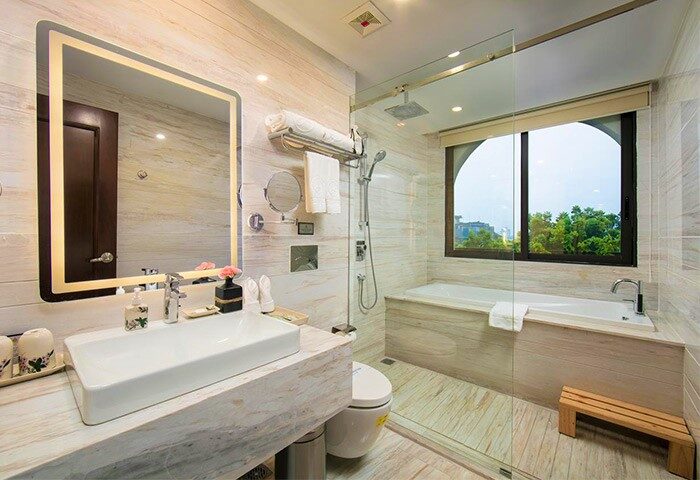Oriental Jade Hotel bathroom. Gay-friendly hotel with tub, shower, and sink. Modern design for gay travelers. Luxury travel experience.
