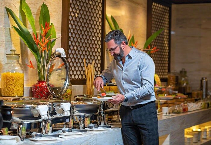 Gay-Friendly Hotel, The Oriental Jade Hotel: Man enjoying the breakfast buffet. A great choice for gay men's travel in Asia.
