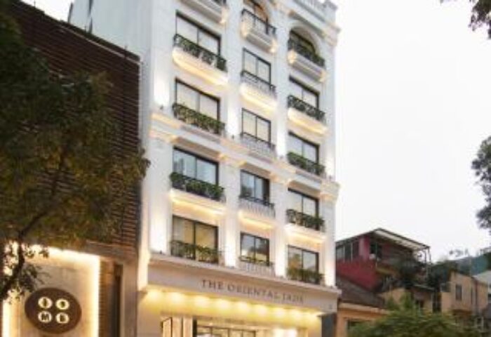 The Oriental Jade Hotel, a gay-friendly hotel in Hanoi. Exterior view of the hotel's facade with a car in front. Gay travel advice.