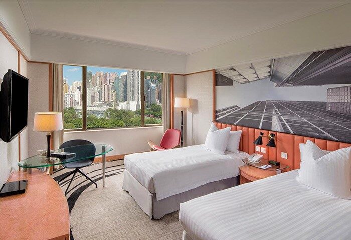 Hotel room at The Park Lane Hong Kong a Pullman Hotel. Twin beds, city view. Gay-friendly travel accommodations in Hong Kong.