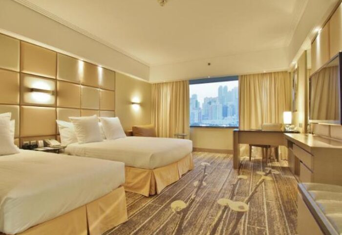 Gay-Friendly The Park Lane Hong Kong a Pullman Hotel room. Twin beds, desk, and city view. Modern design for gay travelers.