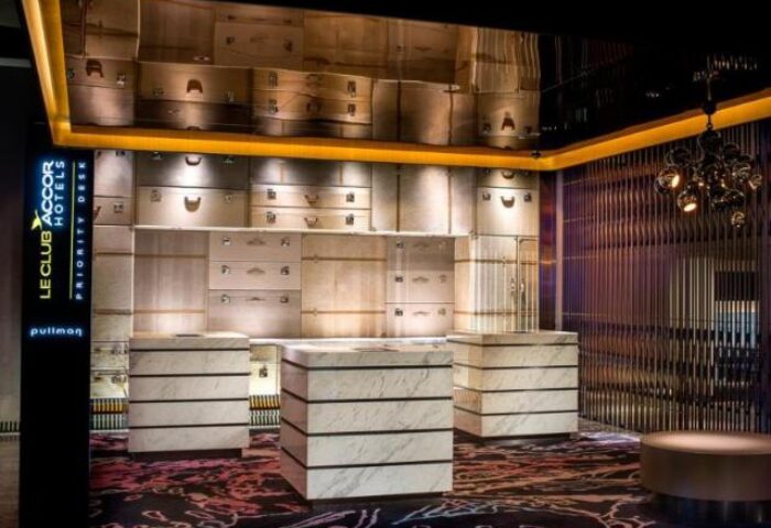 The Park Lane Hong Kong a Pullman Hotel's lobby. Gay-friendly hotel with a unique design. Luggage-themed decor. Upscale travel experience.