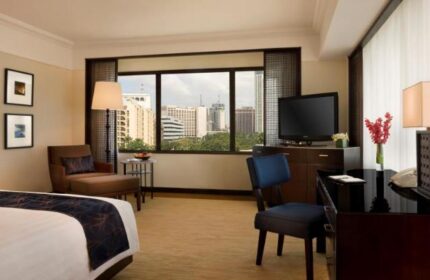 The Peninsula Manila gay-friendly hotel room. City view, TV, desk, and chair. A great choice for gay travelers seeking luxury in Manila.