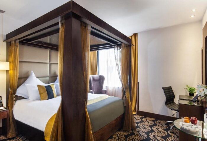 Gay-Friendly Hotel, The Piccadilly London West End: Luxurious four-poster bed in a stylish room. Ideal for gay travelers in London.