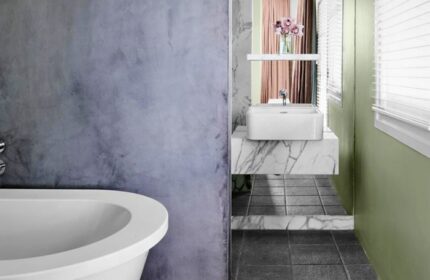 Bathroom at The Prince Hotel, a gay-friendly hotel. Features a modern sink, marble counter, bathtub, and stylish decor. Great for gay travel.