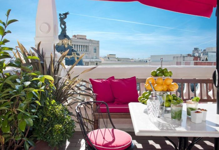 Rooftop terrace at The Principal Madrid Hotel, a gay-friendly hotel. Features drinks, fruit, & city views. Ideal for gay travel in Madrid.