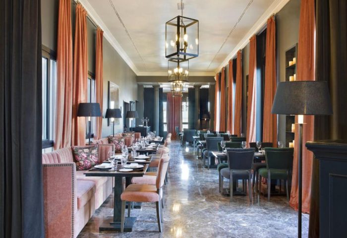 The Principal Madrid Hotel gay-friendly dining room. Elegant restaurant with tables, chairs, and stylish decor. Upscale gay travel.