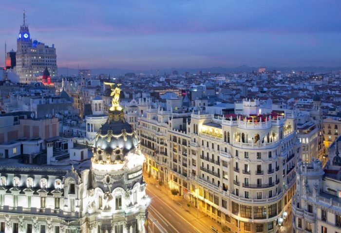 Madrid skyline at twilight. Gay-friendly The Principal Madrid Hotel view. Metropolis Building and city lights. Travel advice for gay men.