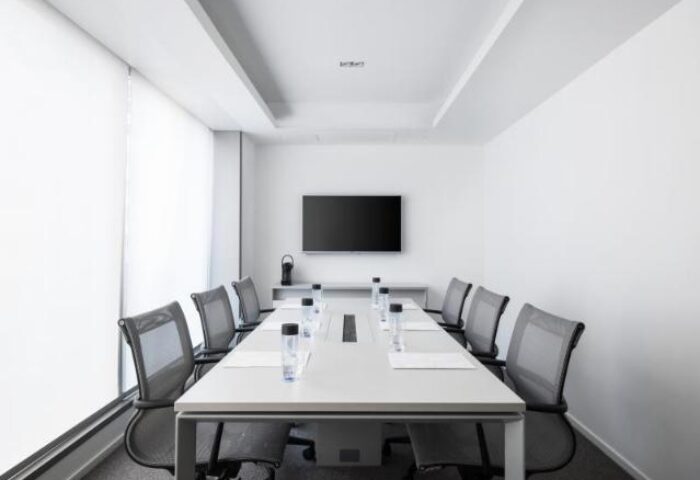 The Putman, a gay-friendly hotel: Modern, bright conference room with a long table, chairs, and a TV screen for meetings.