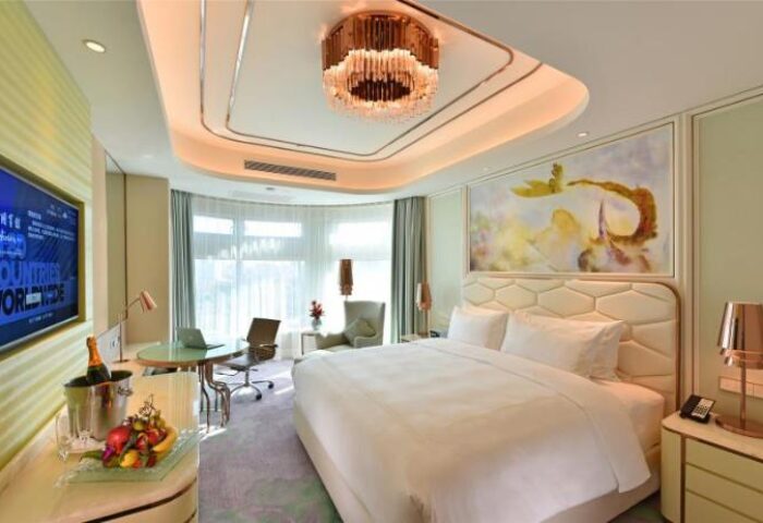 Radisson Collection Hotel Xing Guo Shanghai guest room. Gay-friendly hotel with modern decor, king bed, desk, & city view. Luxury stay in Shanghai.