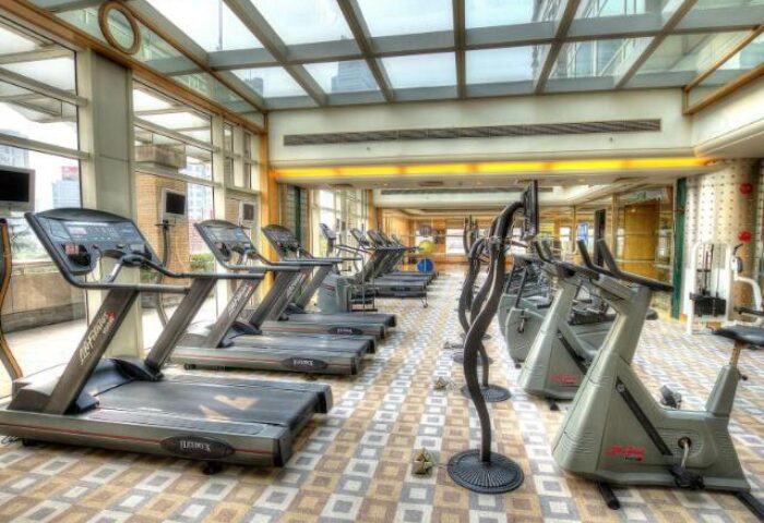 Radisson Collection Hotel Xing Guo Shanghai gym. Treadmills and exercise bikes in a bright, modern fitness center. Gay-friendly hotel.