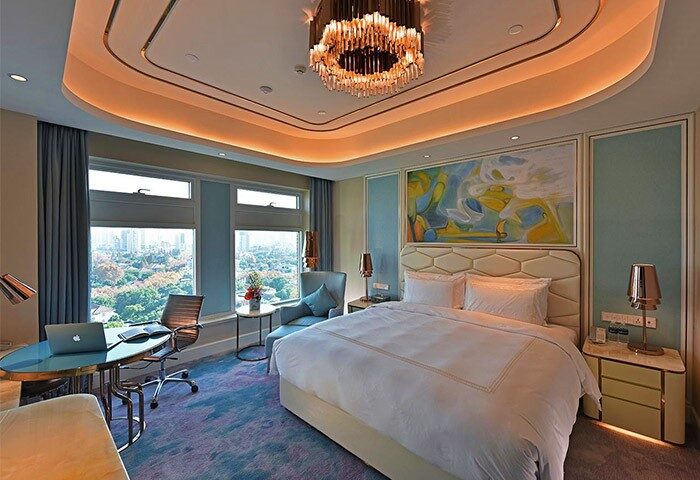 Radisson Collection Hotel Xing Guo Shanghai room. Gay-friendly hotel with bed, desk, city view. Shanghai travel for gay men.