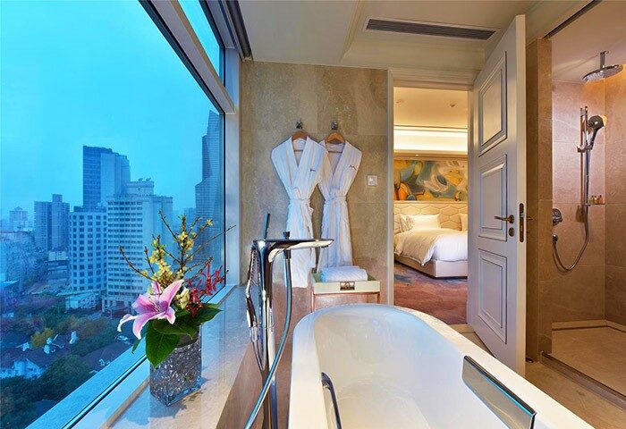 Radisson Collection Hotel Xing Guo Shanghai bathroom with city view. Gay-friendly hotel with bathtub, shower and bedroom. Shanghai travel.