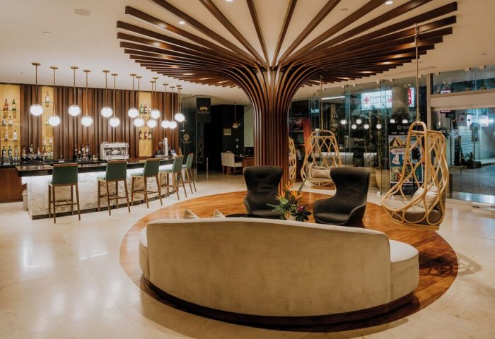The Reef 28 Hotel & Spa lobby. Adults-only, all suites, optional all-inclusive, gay-friendly hotel. Bar, seating, and modern design.