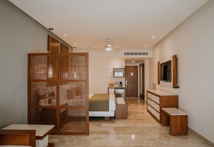 The Reef 28 Hotel & Spa suite interior. Luxury adults-only, all-inclusive option. Gay-friendly hotel room with modern design.
