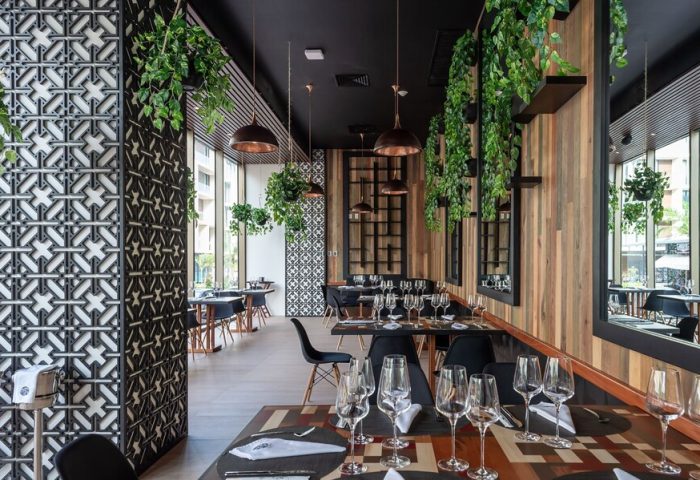 The Reef 28 Hotel & Spa restaurant interior. Luxury adults-only all-suites, optional all-inclusive. Gay-friendly decor with plants.