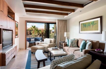 The Ritz-Carlton, Rancho Mirage gay-friendly hotel suite. Living area with balcony, comfortable seating, and stylish decor. Perfect for gay travelers.