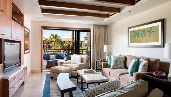 The Ritz-Carlton, Rancho Mirage gay-friendly hotel suite. Living area with balcony, comfortable seating, and stylish decor. Perfect for gay travelers.