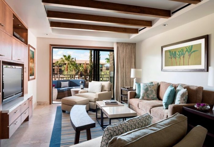 The Ritz-Carlton, Rancho Mirage gay-friendly hotel suite. Living area with balcony, comfortable seating, and stylish decor. Perfect for gay travelers.