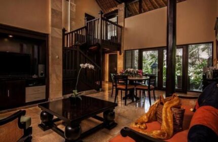 Interior of The Royal Beach Seminyak Bali, MGallery Collection. Gay-friendly hotel with living area, dining table, and staircase. Bali travel.