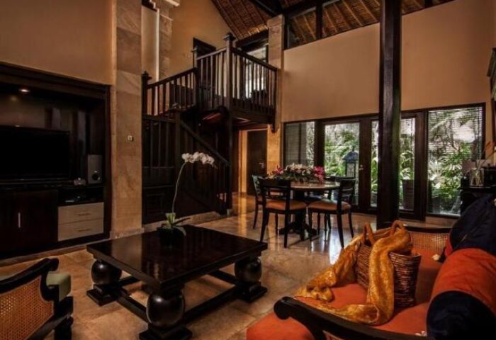 Interior of The Royal Beach Seminyak Bali, MGallery Collection. Gay-friendly hotel with living area, dining table, and staircase. Bali travel.