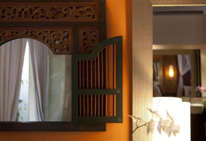 Detail of a mirror at The Royal Beach Seminyak Bali MGallery Collection, a gay-friendly hotel. Decorative Balinese design.