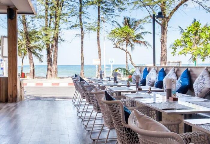 Gay-friendly Royal Palm Beachfront Hotel dining area. Tables and chairs overlook the beach. Ideal gay travel destination.