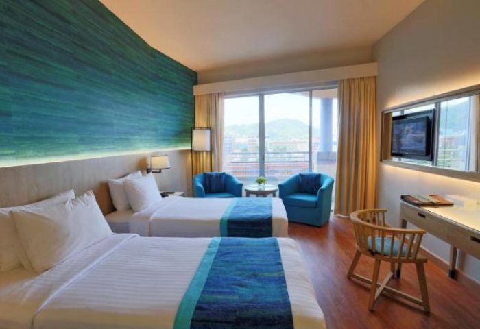 Gay-Friendly The Royal Paradise Hotel & Spa room. Twin beds, blue accents, balcony view. Ideal gay travel hotel for relaxing in style.