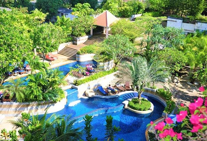 Aerial view of The Royal Paradise Hotel & Spa's pool. This gay-friendly hotel offers a relaxing escape with lush greenery and clear blue waters.