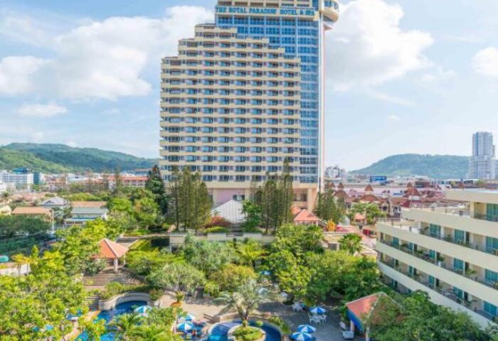 The Royal Paradise Hotel & Spa, a gay-friendly hotel. Features a pool, lush greenery, and views of the city and mountains.
