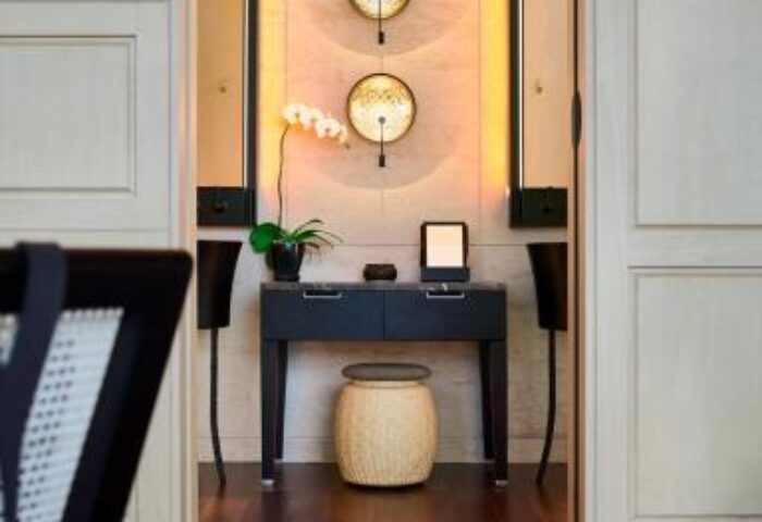The RuMa Hotel and Residences interior. Gay-friendly hotel room detail: desk, stool, orchid, and decorative wall art. Modern design.
