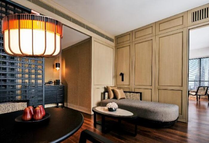 The RuMa Hotel and Residences suite. Gay-friendly hotel room with lounge, table, and city view. Modern design in Kuala Lumpur, Malaysia.