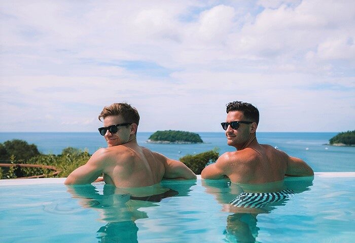 Two men in a pool at The SIS Kata Resort, a gay-friendly hotel. Ocean view. Gay travel advice. Phuket, Thailand.