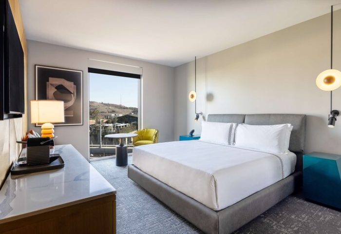 The Shay, A Destination By Hyatt Hotel room. Gay-friendly hotel with bed, desk, and view. Modern design, comfortable, and inviting.