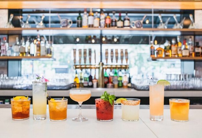 The Shay, a Destination By Hyatt Hotel: colorful cocktails line the bar at this gay-friendly hotel. Perfect for gay men travel advice.