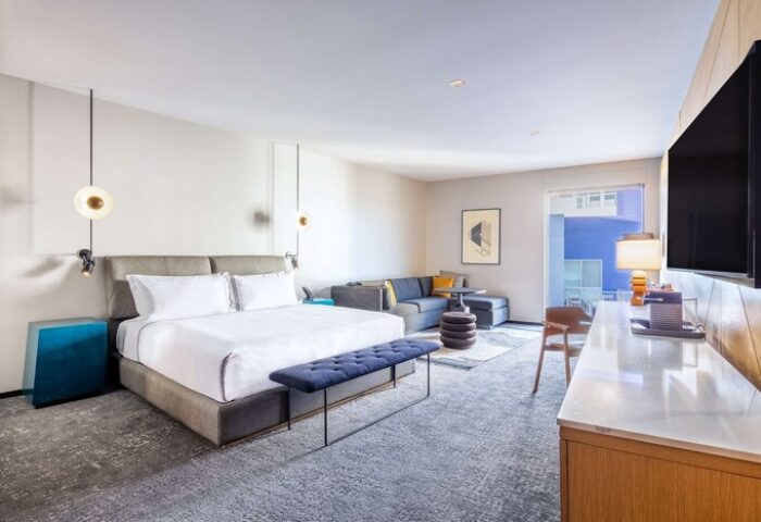 The Shay, A Destination By Hyatt Hotel room. Gay-friendly hotel featuring a king bed, sofa, desk, and balcony. Modern design for gay travelers.