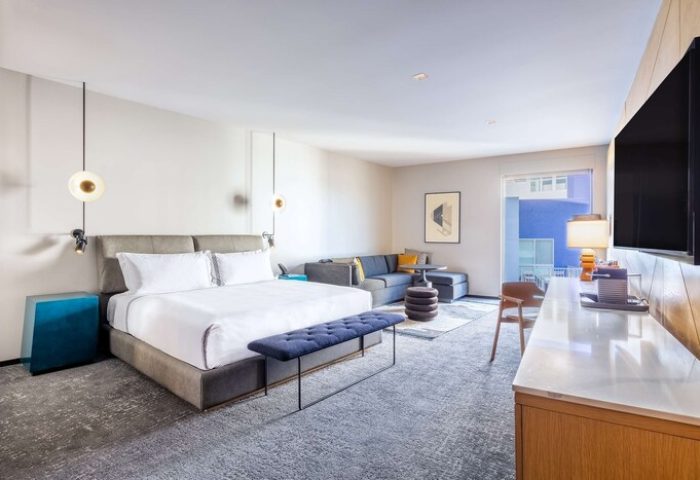 The Shay, A Destination By Hyatt Hotel room. Gay-friendly hotel featuring a king bed, sofa, desk, and balcony. Modern design for gay travelers.