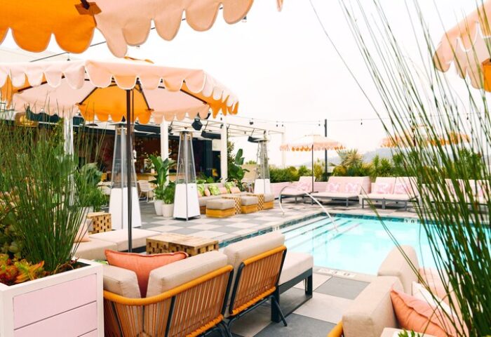Poolside view at The Shay, a Destination by Hyatt Hotel. Gay-friendly hotel with umbrellas, lounge chairs, and a swimming pool.