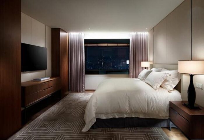 The Shilla Seoul hotel bedroom. Gay-friendly hotel room features a king bed, city views, TV, and modern decor. Perfect for gay men travelers.