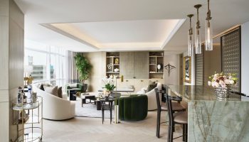 St. Regis Mexico City suite. Upscale gay-friendly hotel living room with bar, neutral tones, and modern design. Luxury Mexico City travel.