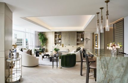 St. Regis Mexico City suite. Upscale gay-friendly hotel living room with bar, neutral tones, and modern design. Luxury Mexico City travel.