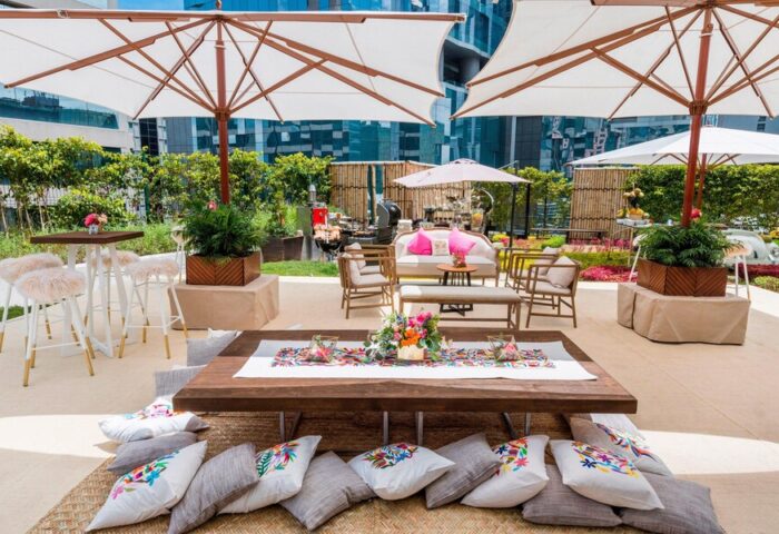 The St. Regis Mexico City gay-friendly hotel outdoor space. Lounge seating, pillows, umbrellas, and tables create a welcoming atmosphere.