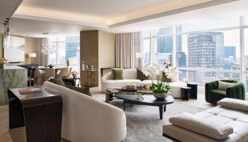 The St. Regis Mexico City gay-friendly hotel suite. Living room with sofas, chairs, city view. Luxury accommodations for gay travelers.