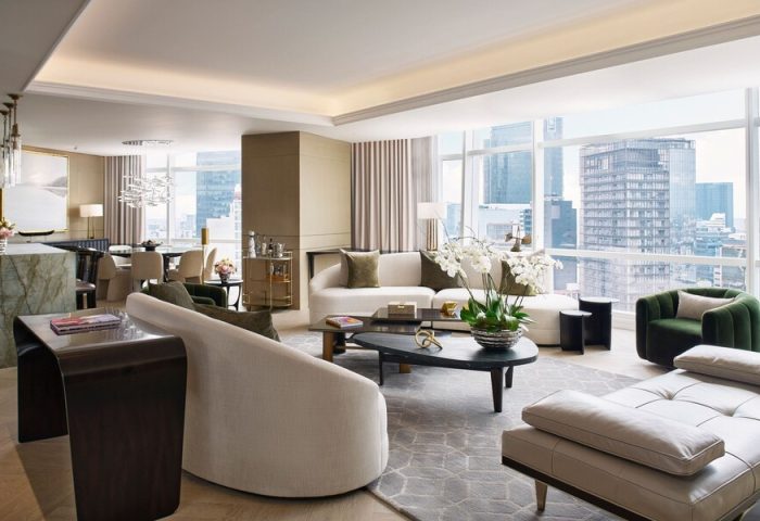 The St. Regis Mexico City gay-friendly hotel suite. Living room with sofas, chairs, city view. Luxury accommodations for gay travelers.