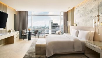 Gay-friendly The St. Regis Mexico City hotel room with a king bed, city view, table, and chairs. Upscale travel for gay men in Mexico City.