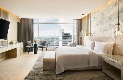 Gay-friendly The St. Regis Mexico City hotel room with a king bed, city view, table, and chairs. Upscale travel for gay men in Mexico City.