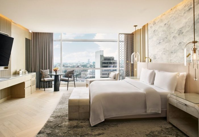 Gay-friendly The St. Regis Mexico City hotel room with a king bed, city view, table, and chairs. Upscale travel for gay men in Mexico City.