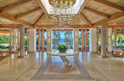 St. Regis Punta Mita Resort lobby. Gay-friendly hotel with ocean view, marble floors, wood ceiling, and modern chandelier. Luxury travel.