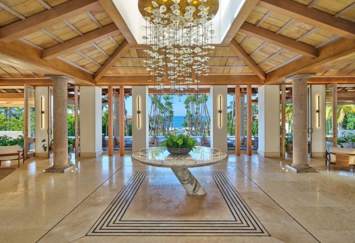 St. Regis Punta Mita Resort lobby. Gay-friendly hotel with ocean view, marble floors, wood ceiling, and modern chandelier. Luxury travel.